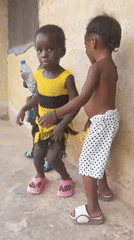 Young children dance and play outdoors in Akwanga, Nigeria