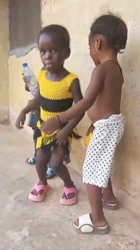 Young children dance and play outdoors in Akwanga, Nigeria