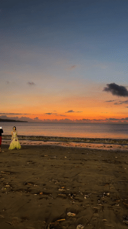 Tourists enjoy typical sunset evening at Kuta Beach, Bali