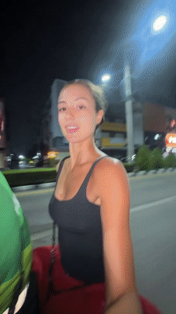 Woman rides Grab motorcycle taxi in Pattaya City