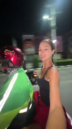 Woman rides Grab motorcycle taxi in Pattaya City