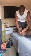 Men provide foot care assistance in living room