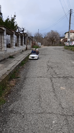 Children playing with bikes, scooters, toys in Bulgarian towns
