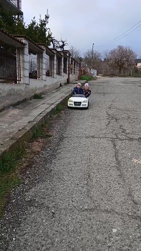 Children playing with bikes, scooters, toys in Bulgarian towns
