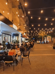 Kuşadası summer night: string lights, cocktails, and harbor views