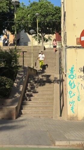 Scooter rider descends stairs, crosses street in Badalona