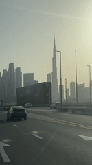 Hazy Dubai skyline captured from road, Burj Khalifa visible
