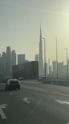 Hazy Dubai skyline captured from road, Burj Khalifa visible