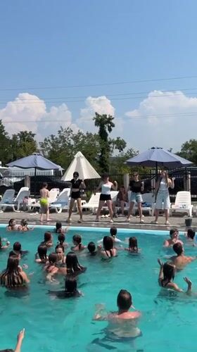 Crowded outdoor pool in Solotvyno on a sunny summer morning