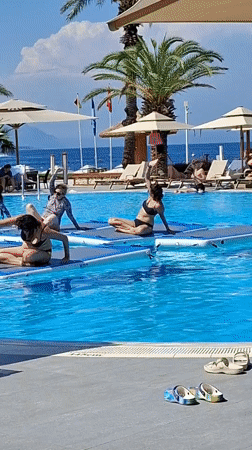 Poolside yoga and coastal scenes at a Kemer resort