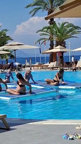 Poolside yoga and coastal scenes at a Kemer resort