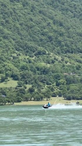 Jet skis and pedal boats on a Georgian mountain lake