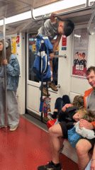 Child plays on handrails during Milan Metro evening commute