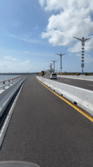 Motorcycle rider crosses bridge in South Denpasar