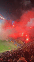 Soccer fans light red flares during 0-0 match in Tel Aviv