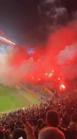 Soccer fans light red flares during 0-0 match in Tel Aviv