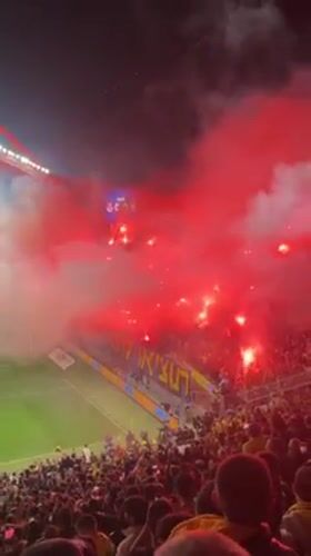 Soccer fans light red flares during 0-0 match in Tel Aviv