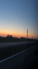 Highway sunset captured from moving vehicle in Poland