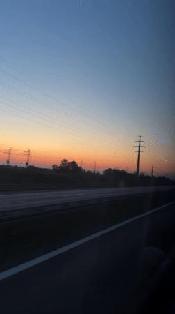 Highway sunset captured from moving vehicle in Poland