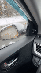 Driver navigates snowy road conditions in Zaovrazh'e, Russia