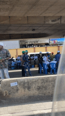 Community gathering under Lagos overpass draws crowd with chairs