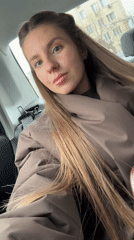 Woman in brown jacket observed in vehicle backseat, Moscow
