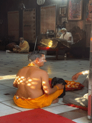 Temple devotee organizes garlands in Vrindavan sacred space