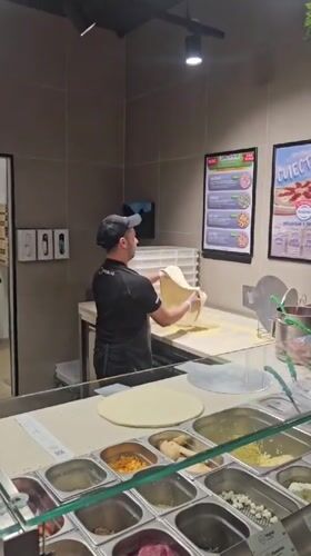 Pizza prep behind the counter in Stara Zagora