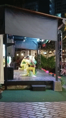 Nighttime outdoor performance features three performers in Porlamar, Venezuela
