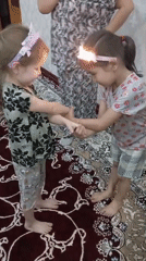 Children play games, dance indoors in Bekabad home