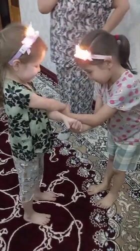 Children play games, dance indoors in Bekabad home