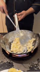 Chef prepares pasta dish in Maldives kitchen