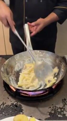 Chef prepares pasta dish in Maldives kitchen