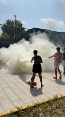 Hose spraying mist on a sunny day in Daxing District