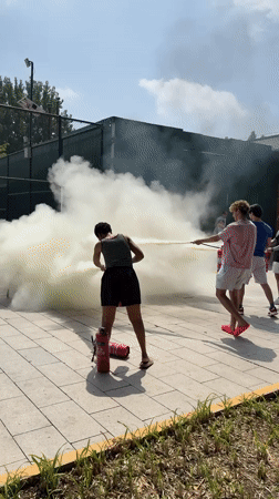 Hose spraying mist on a sunny day in Daxing District
