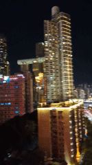 Chongqing riverfront at night: skyline, tour boats, city streets