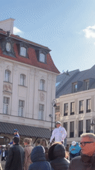 Street musician performs violin in Warsaw public square