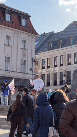 Street musician performs violin in Warsaw public square