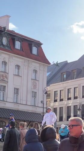 Street musician performs violin in Warsaw public square