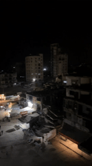 Evening street activity observed in Gaza amid damaged buildings