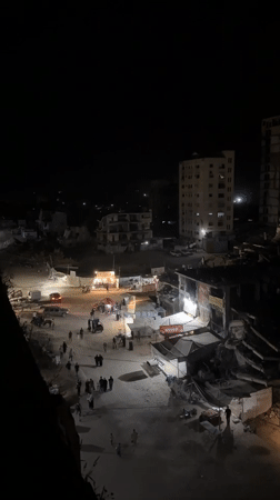 Evening street activity observed in Gaza amid damaged buildings
