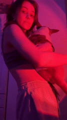 Woman photographed with corgi in colorfully lit Moscow apartment