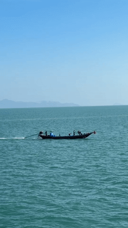 Ferry crossing on turquoise waters off Don Sak, Thailand