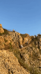 Blanes coastline in full summer swing, cliff to beach
