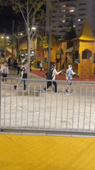 Children play with foam at nighttime playground in Kiryat Motzkin