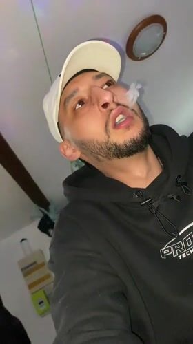 Man vapes under colorful lights in Bischheim, France