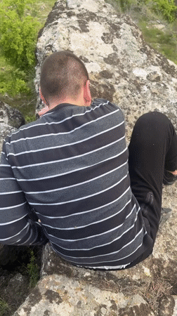 Person explores rocky overlook above Goritsa valley, Bulgaria