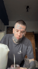 Tattooed person prepares hot beverage in Buenos Aires
