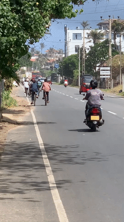 Ahangama coast: roadside traffic, rocky shore, and storm debris
