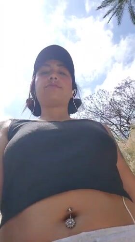 Woman documented during afternoon walk through blooming Murcia parklands